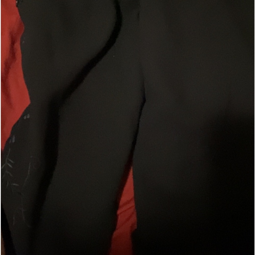 Long, wide trousers with floral black embellishments and beads